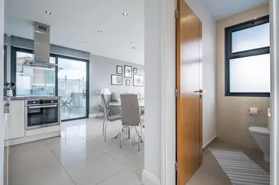 a kitchen and dining room with a dining table at Hillside Villa in Arco da Calheta