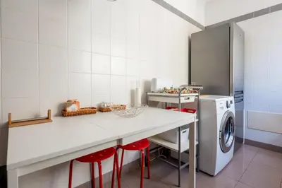 a kitchen with a counter and a washing machine at Caniço I By Trip2Portugal in Caniço
