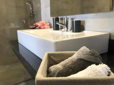 a bathroom with a sink and a bath tub at Moradia Syso in Arco da Calheta
