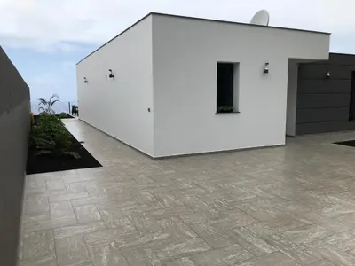 a white building with a tile floor at Moradia Syso in Arco da Calheta