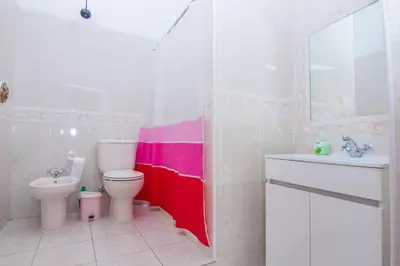 a bathroom with a toilet and a sink at Akivillas Lagos Quiet in Barão de São Miguel