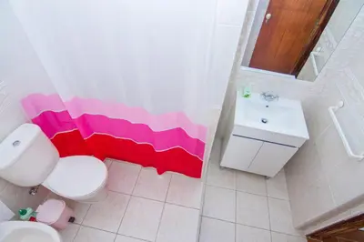 a bathroom with a white toilet and a sink at Akivillas Lagos Quiet in Barão de São Miguel
