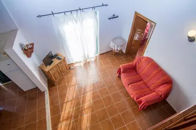 an orange pillow sitting on the floor of a room at Akivillas Lagos Quiet in Barão de São Miguel