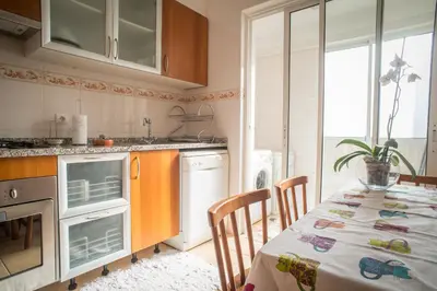 a kitchen with a table with a tablecloth on it at Helen´s House Apartment in Câmara de Lobos