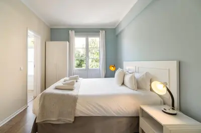 a bedroom with a white bed and a window at Barreirinha II Near Old Town With Nice Ocean Views in Funchal