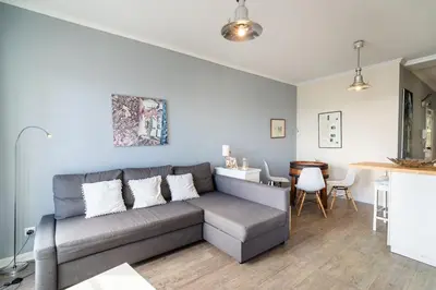 a living room with a gray couch and a table at Barreirinha II Near Old Town With Nice Ocean Views in Funchal