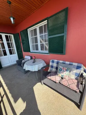 a patio with a couch and a table on a house at Ponta do Sol Villa in Ponta do Sol