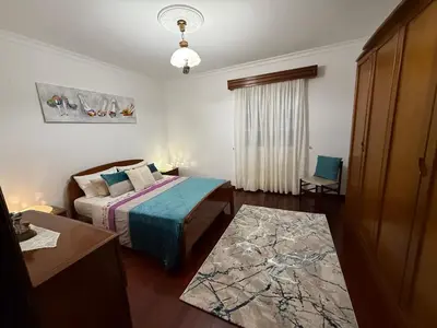 a small bedroom with a bed and a rug at Ponta do Sol Villa in Ponta do Sol