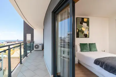 a bedroom with a bed and a balcony at Casa dos Filhos by Rent2U, Lda in Funchal
