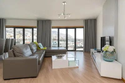 a living room with a couch and a tv at Casa dos Filhos by Rent2U, Lda in Funchal
