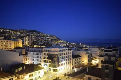 a view of a city at night at Casa dos Filhos by Rent2U, Lda in Funchal