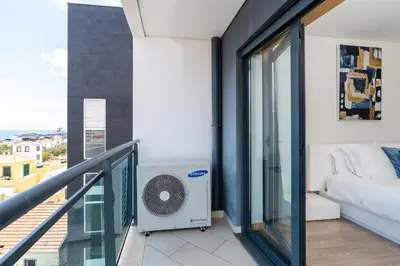a balcony with a bed and a air conditioner at Casa dos Filhos by Rent2U, Lda in Funchal