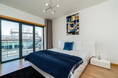 a bedroom with a bed and a large window at Casa dos Filhos by Rent2U, Lda in Funchal