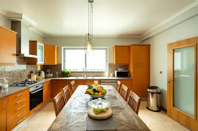 a kitchen with a table with a bowl of fruit on it at Villa Abreu - A Wonderful Ocean View in Calheta