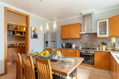 a kitchen with a table with a bowl of fruit on it at Villa Abreu - A Wonderful Ocean View in Calheta