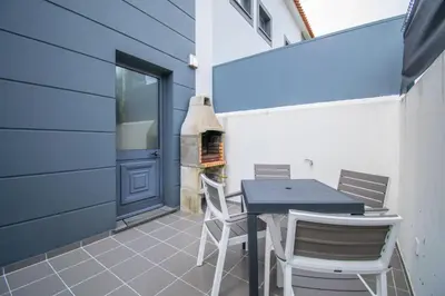 a patio with a table and chairs and a fireplace at Casa da Graça by AnaLodges in Machico