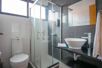 a bathroom with a glass shower and a toilet at Casa da Graça by AnaLodges in Machico
