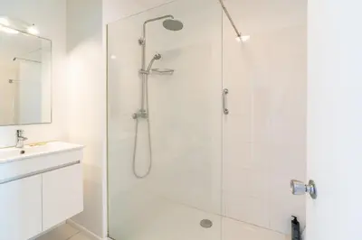 a white bathroom with a shower and a sink at Lido Mar - Hotels area in Funchal