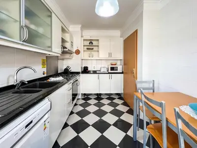 a kitchen with a black and white checkered floor at Garajau Terrace - Amazing Views of Garajau Town in Garajau