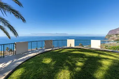 a view of the ocean from the balcony of a house at Atlantic Ocean View Apartment in Funchal