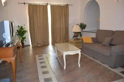 a living room with a couch and a coffee table at Palm Bay Apartment in Luz