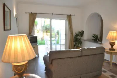a living room with a couch and a table with lamps at Palm Bay Apartment in Luz