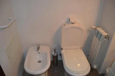 a small bathroom with a toilet and a bidet at Palm Bay Apartment in Luz