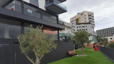 a living room with a couch and a glass table at Astro Madeira Apartments in Funchal