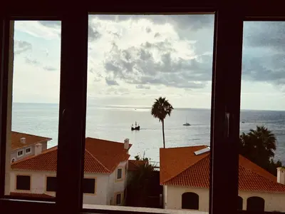 a view of the ocean from a window at Ocean Cliffs Apartments in Funchal