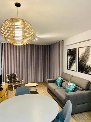 a living room with a couch and a table at Ocean Cliffs Apartments in Funchal