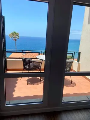 a view of a balcony with a table and chairs at Ocean Cliffs Apartments in Funchal