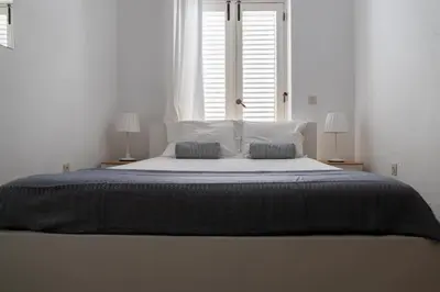 a bedroom with a large bed with two pillows at Beach House at Praia da Luz in Luz