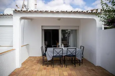 a table and chairs sitting on a patio at Beach House at Praia da Luz in Luz