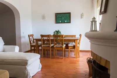 a dining room with a table and chairs at Beach House at Praia da Luz in Luz
