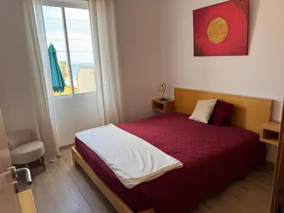 a living room with a couch and a kitchen at Casa das Cruzes in Funchal