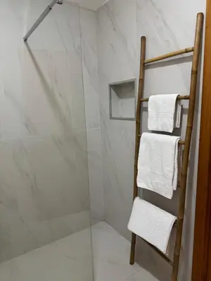 a towel rack in a bathroom with a glass shower at Casa das Cruzes in Funchal