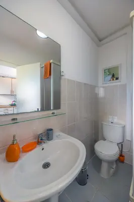 a bathroom with a white sink and a toilet at Vista Oceano II in Caniço