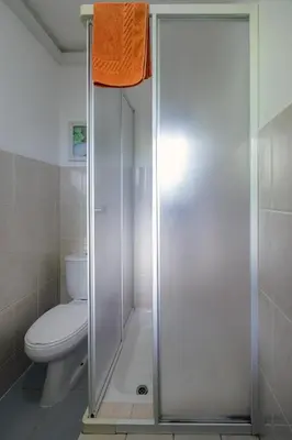 a shower stall in a bathroom with a toilet at Vista Oceano II in Caniço