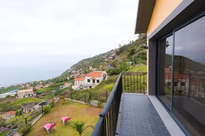 a balcony with a view of a hill at Casa do Louro in Arco da Calheta