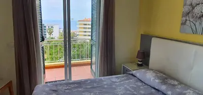 a bedroom with a bed and a view of a balcony at Tulipa View Apartament in Funchal