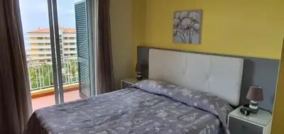 a bedroom with a bed and a large window at Tulipa View Apartament in Funchal