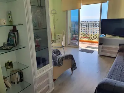a living room with a tv and a living room with a couch at Tulipa View Apartament in Funchal