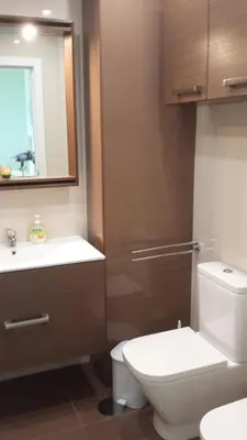 a bathroom with a toilet and a sink and a mirror at Tulipa View Apartament in Funchal
