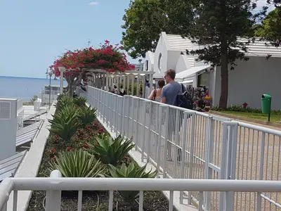 a man and woman walking along a white fence at Tulipa View Apartament in Funchal