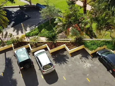 an overhead view of two cars parked in a parking lot at Tulipa View Apartament in Funchal