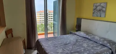 a bedroom with a bed and a view of a balcony at Tulipa View Apartament in Funchal