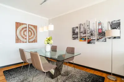a dining room with a glass table and chairs at Oceanside Terrace Apartment by Holiday Rental Madeira in Funchal