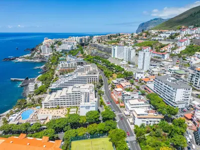 an aerial view of a city next to the ocean at Oceanside Terrace Apartment by Holiday Rental Madeira in Funchal