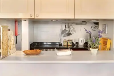 a kitchen with a white counter top and cabinets at Luzias Apartment in Funchal