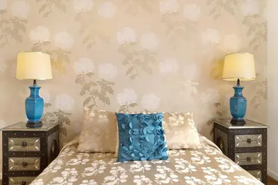 a bedroom with two blue vases on top of a bed at Luzias Apartment in Funchal